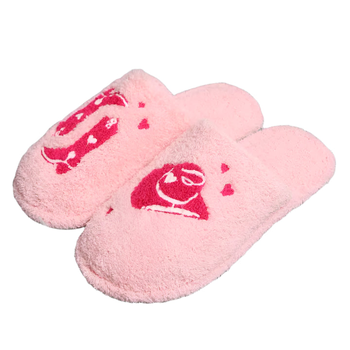 Pink slippers with a red logo on a gray textured surface