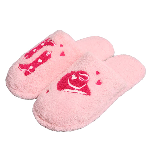 Pink slippers with a red logo on a gray textured surface