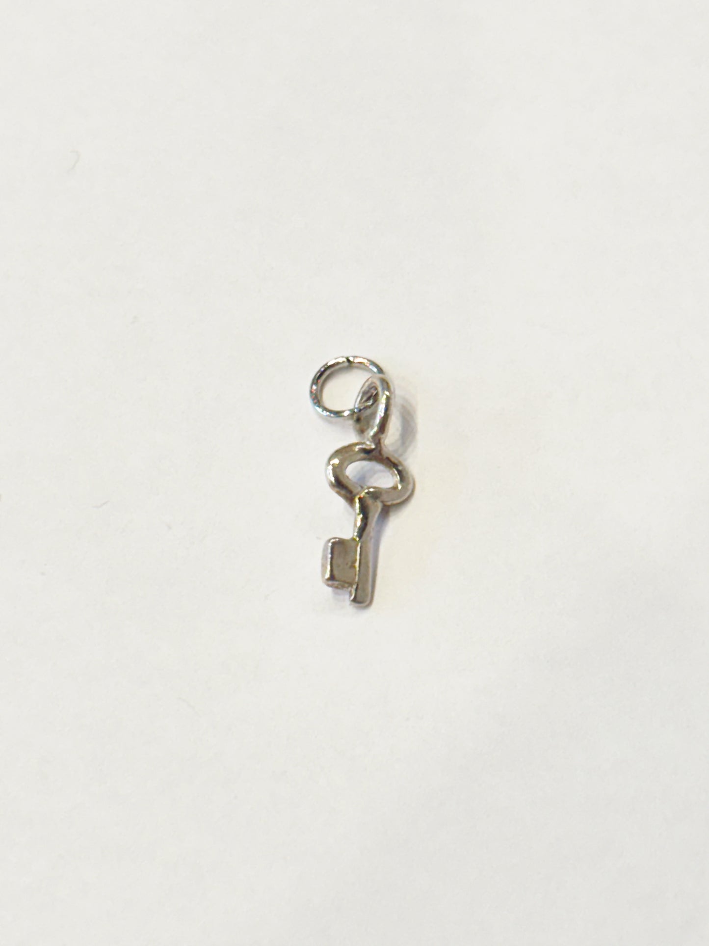 TINY SILVER KEY CHARM